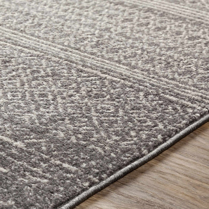 Mckinney Area Rug, gray textured plush by Boutique Rugs with a rolled edge on wood floor on Tampa Home & Garden Store