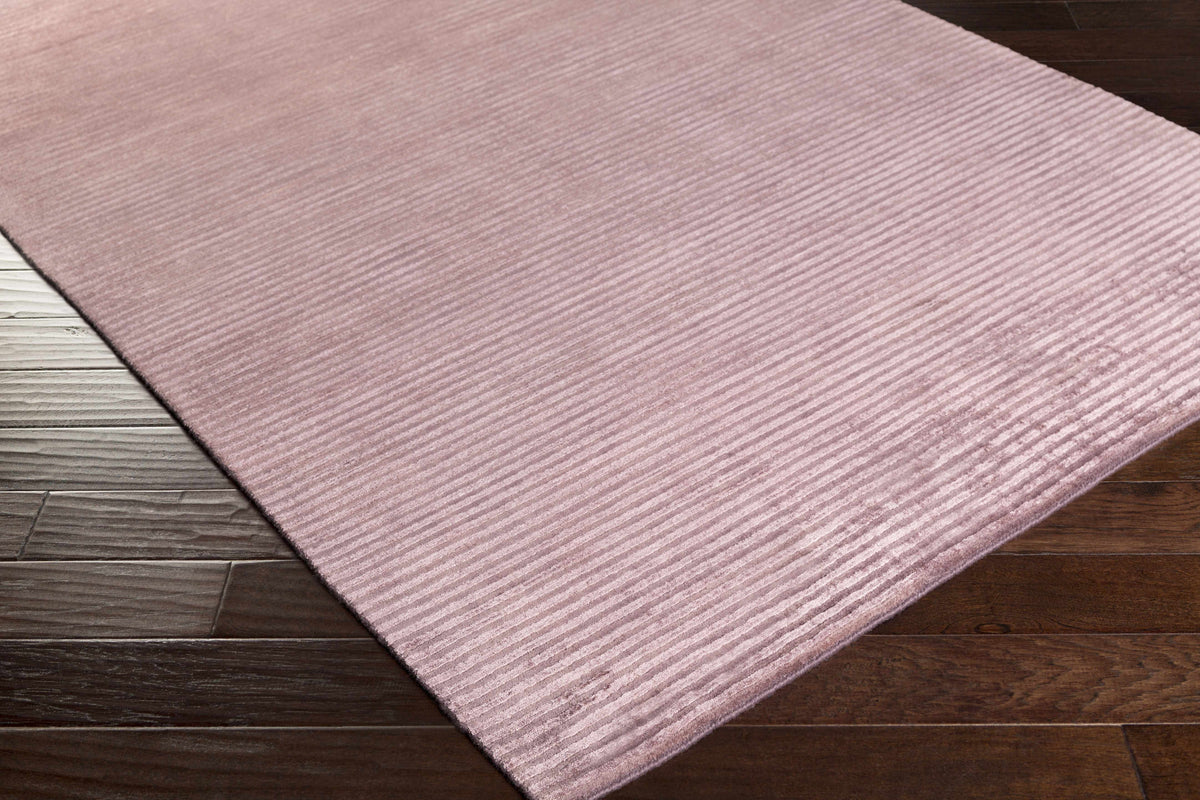 Meador Area Carpet rug by Boutique Rugs in dusty rose with ribbed texture on wood floor on Tampa Home & Garden Store