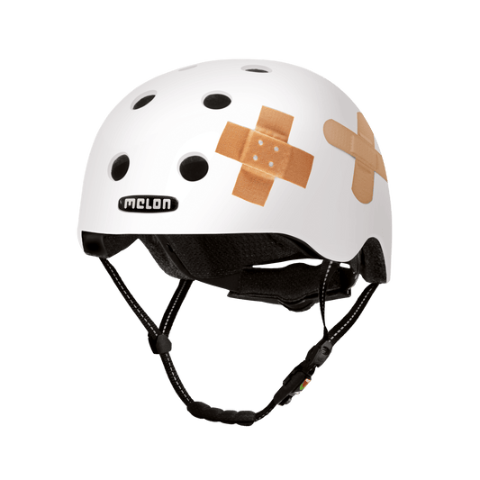 Melon Helmets plastered white bicycle helmet with beige bandage patches and ventilation holes on Tampa Home & Garden Store