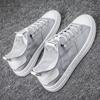 Gray canvas sneakers with white toe caps, lace-up low-top Stevvex casual sneakers pair on Tampa Home & Garden Store