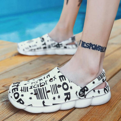 Stevvex white slip-on sandals for men with black text graphic print, two sandals on wood deck on Tampa Home & Garden Store
