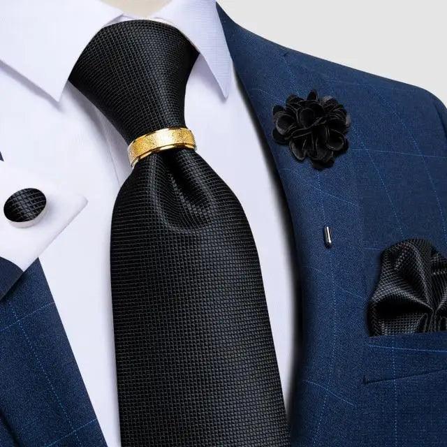 Men's black textured silk necktie with gold tie clip on a blue suit on Tampa Home & Garden Store