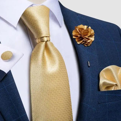 Men's luxury gold silk necktie Stevvex with accessories on navy suit and boutonniere on Tampa Home & Garden Store