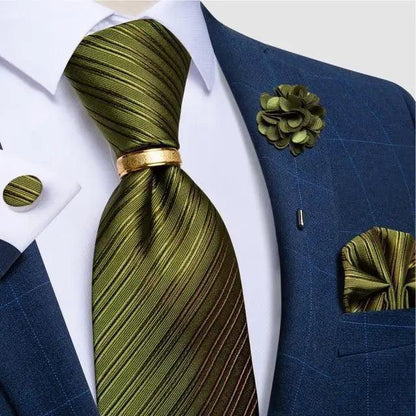 Stevvex olive green striped silk necktie with gold tie bar, paired with blue suit and boutonniere on Tampa Home & Garden Store