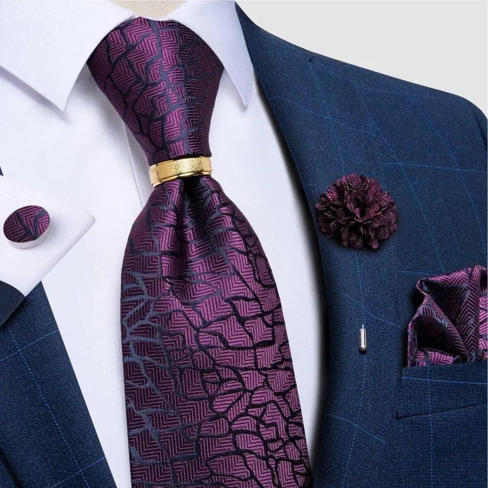 Stevvex red silk necktie with pattern, matching cufflinks and gold tie clip on navy suit on Tampa Home & Garden Store