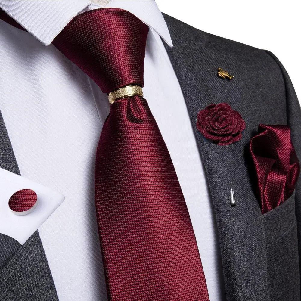 Men's red silk necktie with matching cufflinks on gray suit; pocket square and gold tie bar on Tampa Home & Garden Store