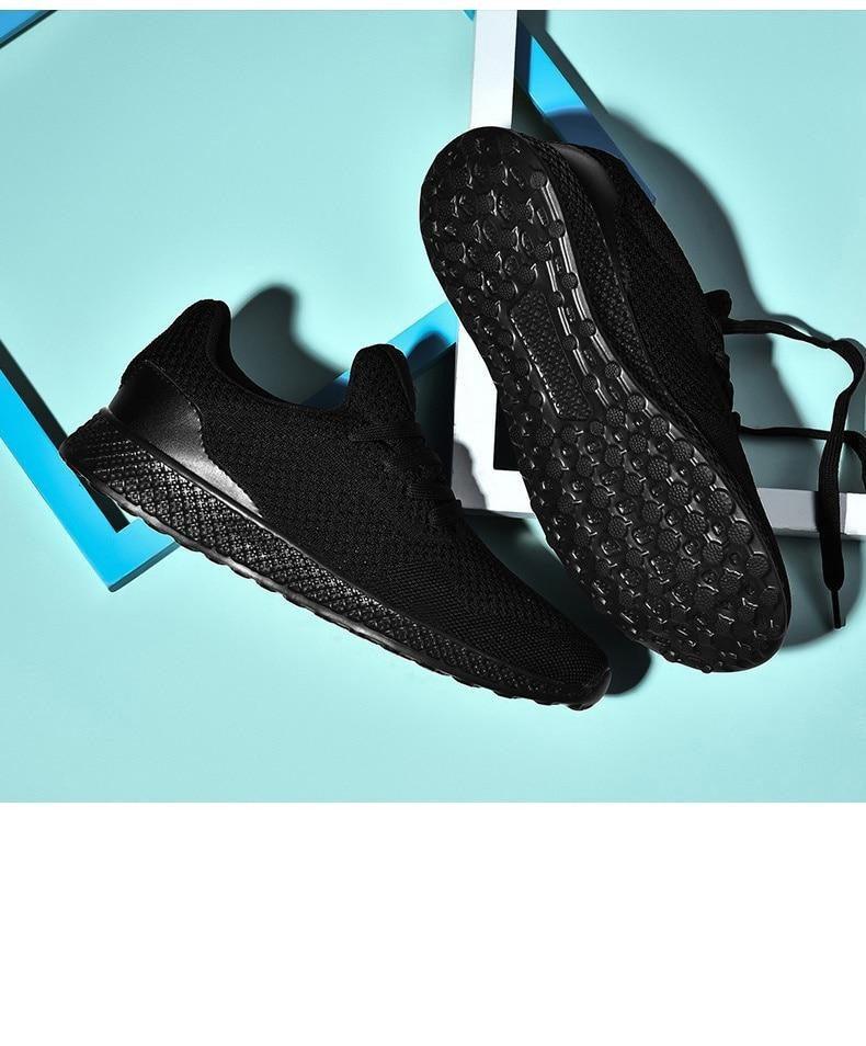 Pair of men's black Stevvex sneakers with breathable mesh upper, lace-up athletic running shoes on Tampa Home & Garden Store