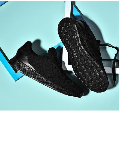 Pair of men's black Stevvex sneakers with breathable mesh upper, lace-up athletic running shoes on Tampa Home & Garden Store
