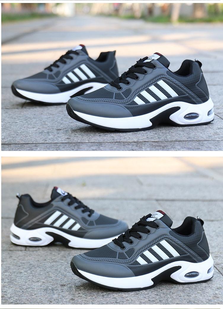 Pair of grey leather sneakers with black overlays and white stripe accents, chunky white sole on Tampa Home & Garden Store