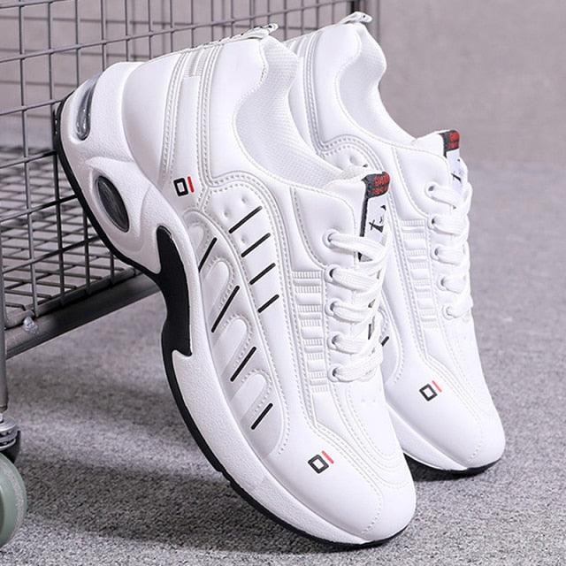 Pair of men's white leather casual sneakers with chunky sole, stitched panels on Tampa Home & Garden Store