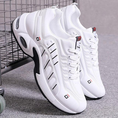 Pair of men's white leather casual sneakers with chunky sole, stitched panels on Tampa Home & Garden Store