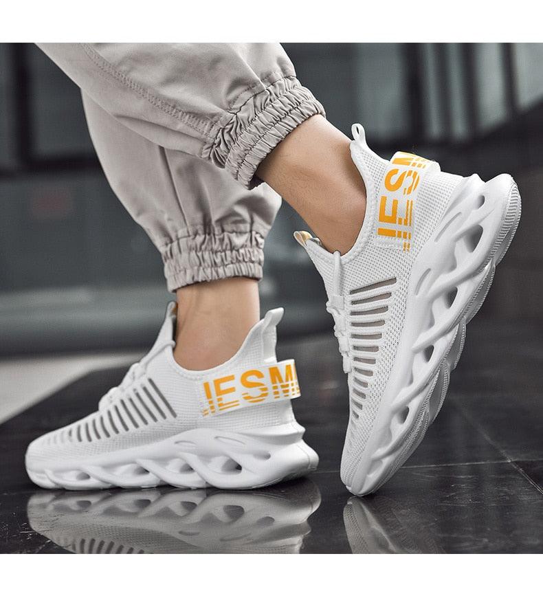 Stevvex men's luxury sneakers pair, white breathable knit upper, orange branding, sculpted sole on Tampa Home & Garden Store