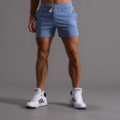 Men's blue athletic shorts with drawstring, paired with white Adidas sneakers on Tampa Home & Garden Store