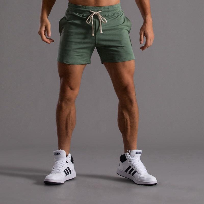 Stevvex men's green sports shorts with drawstring; quick-dry fabric, white Adidas sneakers on Tampa Home & Garden Store