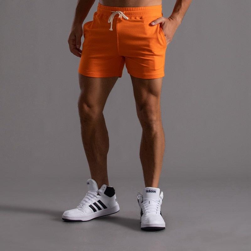 Stevvex men's orange sports shorts with drawstring, breathable quick-dry fabric, Adidas sneakers on Tampa Home & Garden Store