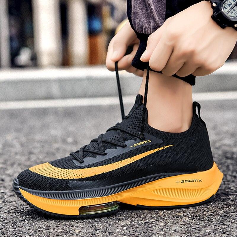Men's Stevvex training sneakers, black mesh upper with orange accents and air-cushion sole on Tampa Home & Garden Store