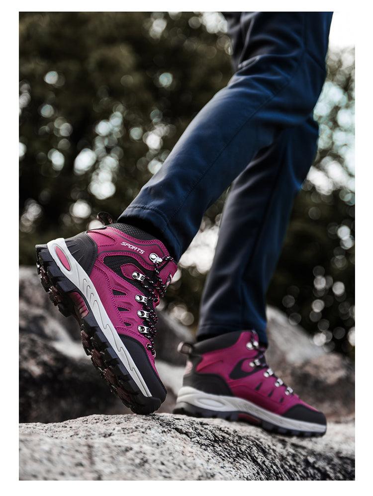 Pair of Stevvex pink and black high-top hiking boots with breathable leather and rugged non-slip outsole on rocky trail on Tampa Home & Garden Store
