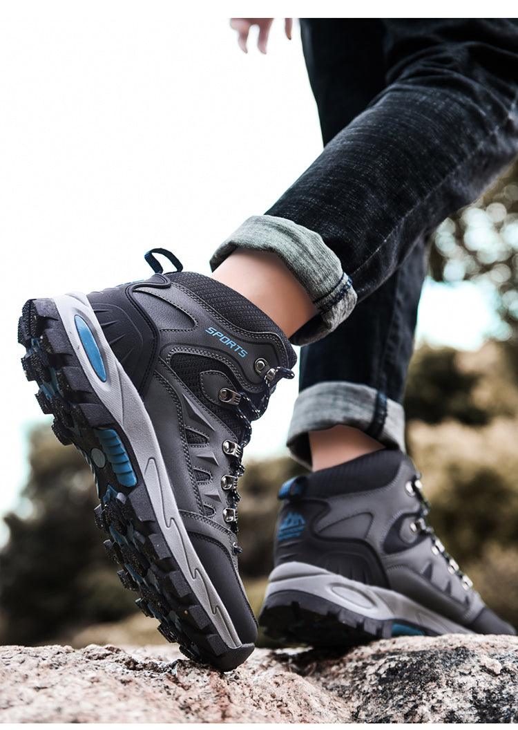 Hiking boots gray-black with rugged tread and blue accents on outdoor surface on Tampa Home & Garden Store
