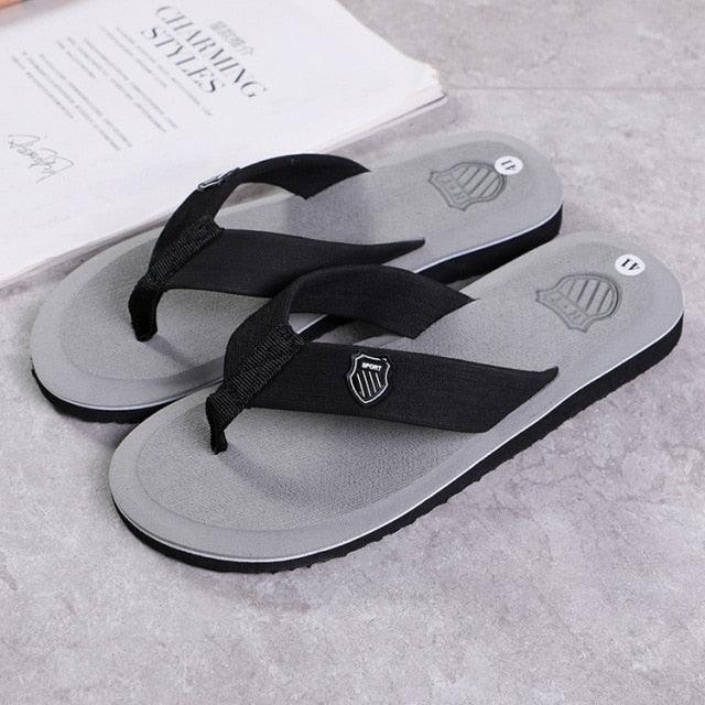 Stevvex flip flops sandals pair with grey footbed and black straps shield logo on strap on Tampa Home & Garden Store