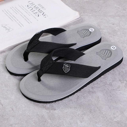 Stevvex flip flops sandals pair with grey footbed and black straps shield logo on strap on Tampa Home & Garden Store