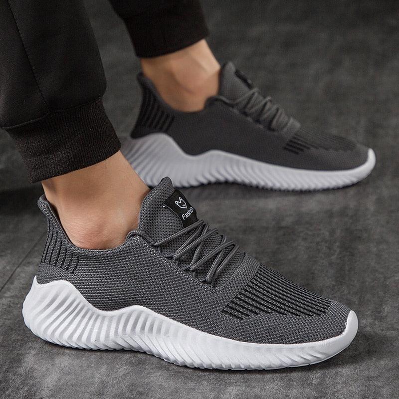 Pair of men's Stevvex breathable grey mesh sneakers with white wavy sole for walking and running on Tampa Home & Garden Store