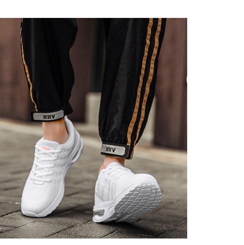 Men's Stevvex white breathable mesh running sneakers with air cushion sole on sidewalk on Tampa Home & Garden Store