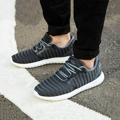 Pair of Stevvex men's lightweight running sneakers with gray striped knit upper and white sole on Tampa Home & Garden Store