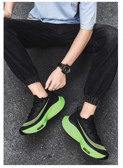 Pair of black knit running sneakers with neon green air-cushioned sole breathable lightweight on Tampa Home & Garden Store