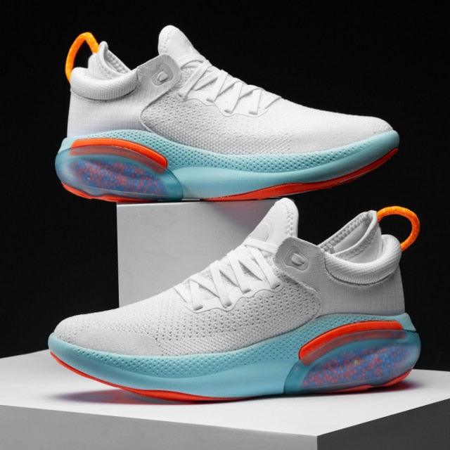 Stevvex mens sneakers white mesh teal midsole orange accents two on display on Tampa Home & Garden Store