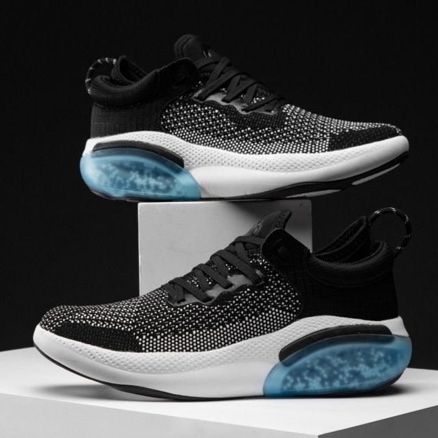 Sneakers Stevvex black knit upper, white sole with blue heel cushion, 2 sneakers on display on Tampa Home & Garden Store