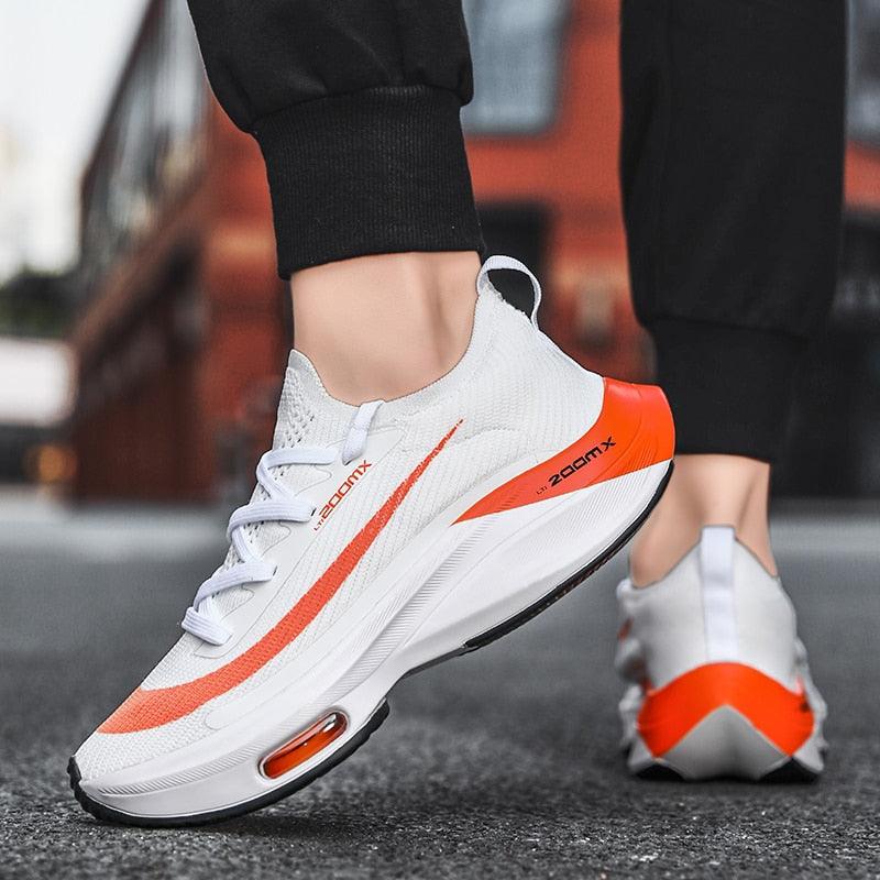 Mens running sneakers Stevvex white with orange accents, breathable knit upper on Tampa Home & Garden Store