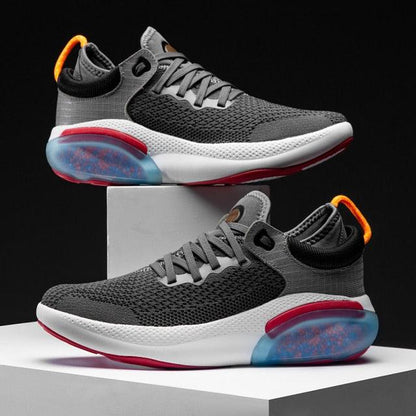 Two men's grey knit running sneakers with white midsole and orange pull tab, blue heel pod on Tampa Home & Garden Store