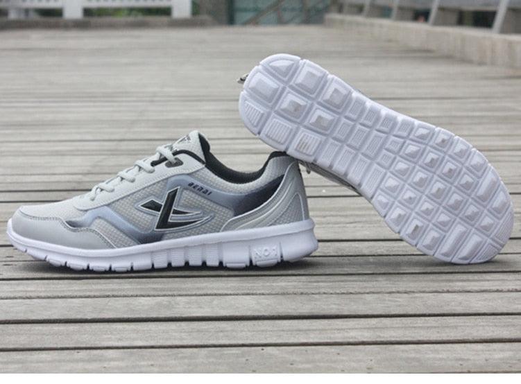 Mens running sneakers Stevvex breathable mesh lightweight white gray pair on wooden deck on Tampa Home & Garden Store