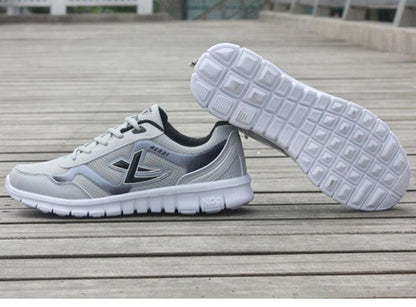 Mens running sneakers Stevvex breathable mesh lightweight white gray pair on wooden deck on Tampa Home & Garden Store