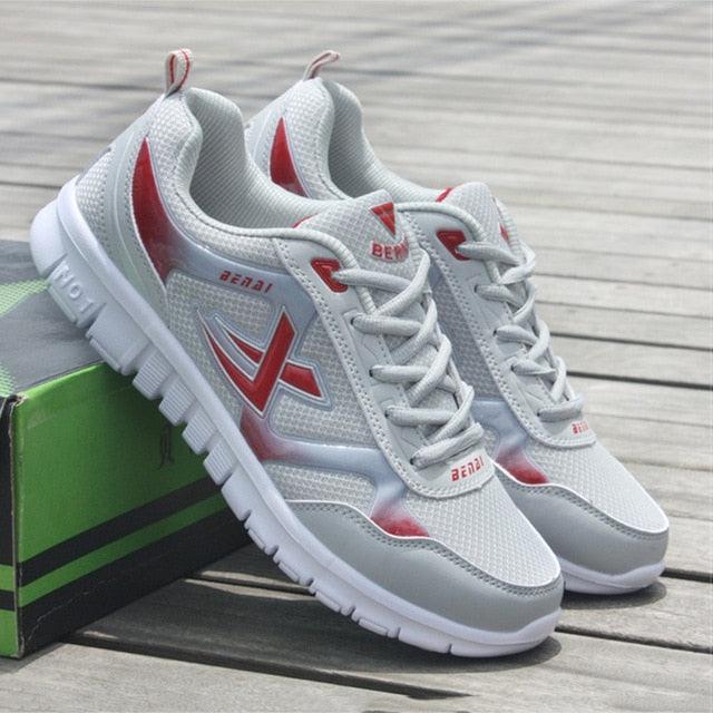 Stevvex Mens sport running sneakers, breathable white mesh with red accents, pair on Tampa Home & Garden Store