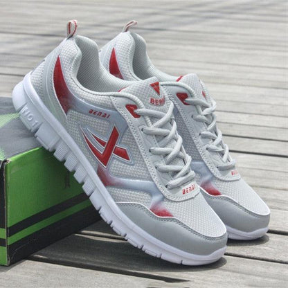 Stevvex Mens sport running sneakers, breathable white mesh with red accents, pair on Tampa Home & Garden Store