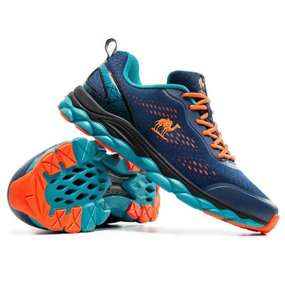 Stevvex athletic running shoes pair, navy blue mesh with orange laces, turquoise outsole on Tampa Home & Garden Store