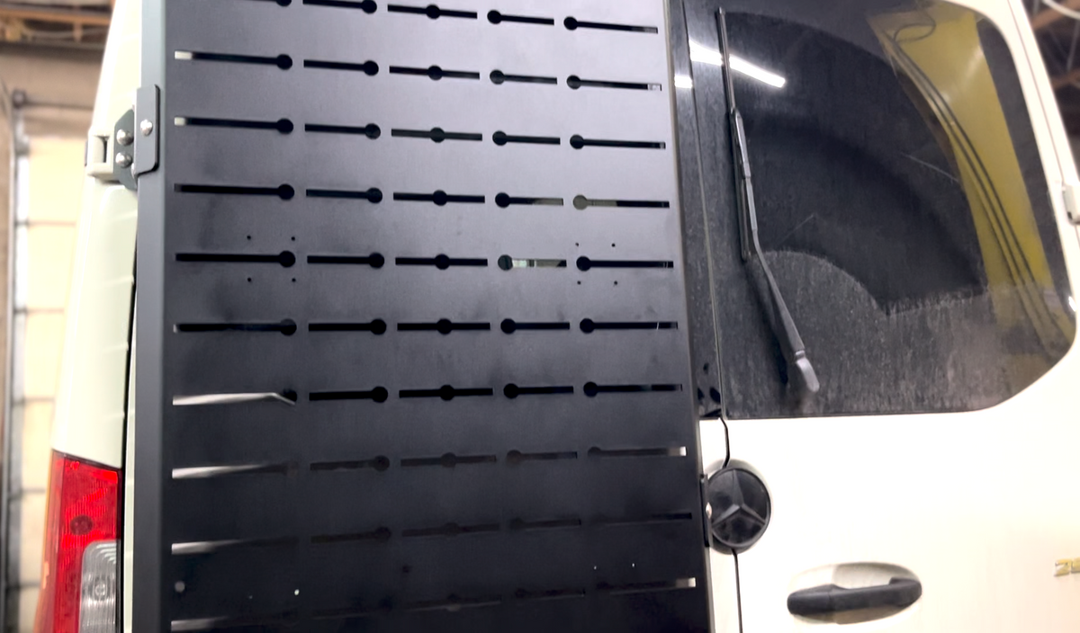 Avatar Sir Packs-a-lot storage mounting solution panel on a white van with black perforated slots on Tampa Home & Garden Store