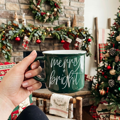 Merry & Bright Gia Roma mug, green ceramic with white script in a festive setting on Tampa Home & Garden Store