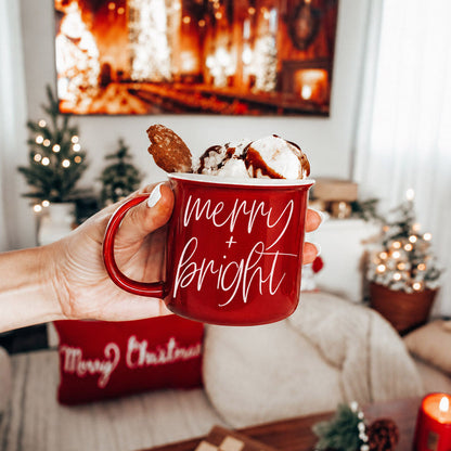 Merry & Bright red ceramic coffee mug with white script, topped with whipped cream and a cookie on Tampa Home & Garden Store