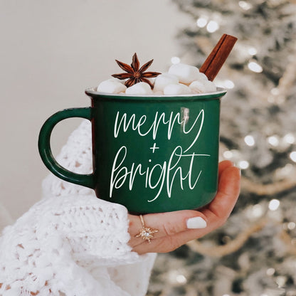 Merry & Bright coffee mug by Gia Roma, green ceramic with white script, marshmallows on Tampa Home & Garden Store