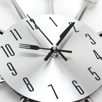 Stevvex metal kitchen wall clock with brushed aluminum dial and cutlery-shaped hands on Tampa Home & Garden Store