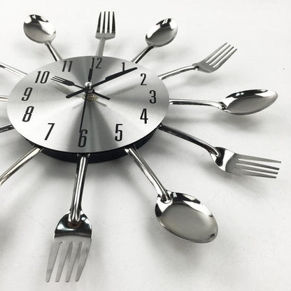 Stevvex metal kitchen wall clock with 3D sunburst cutlery rays in silver, round quartz face on Tampa Home & Garden Store