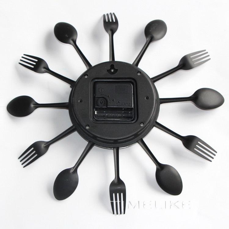 Stevvex black kitchen wall clock with 12 utensil spokes back view shows battery compartment on Tampa Home & Garden Store