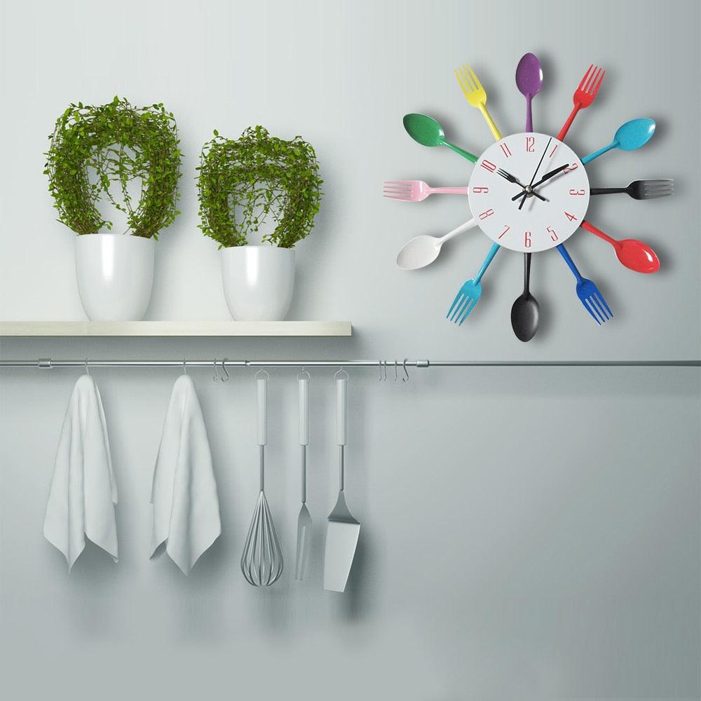 Stevvex metal kitchen wall clock with white face and colorful spoon and fork accents on Tampa Home & Garden Store