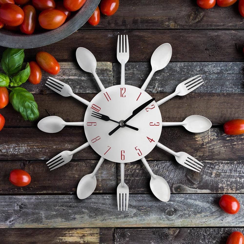 Stevvex metal kitchen wall clock with sunburst spoon and fork rays, white dial with red numerals on Tampa Home & Garden Store