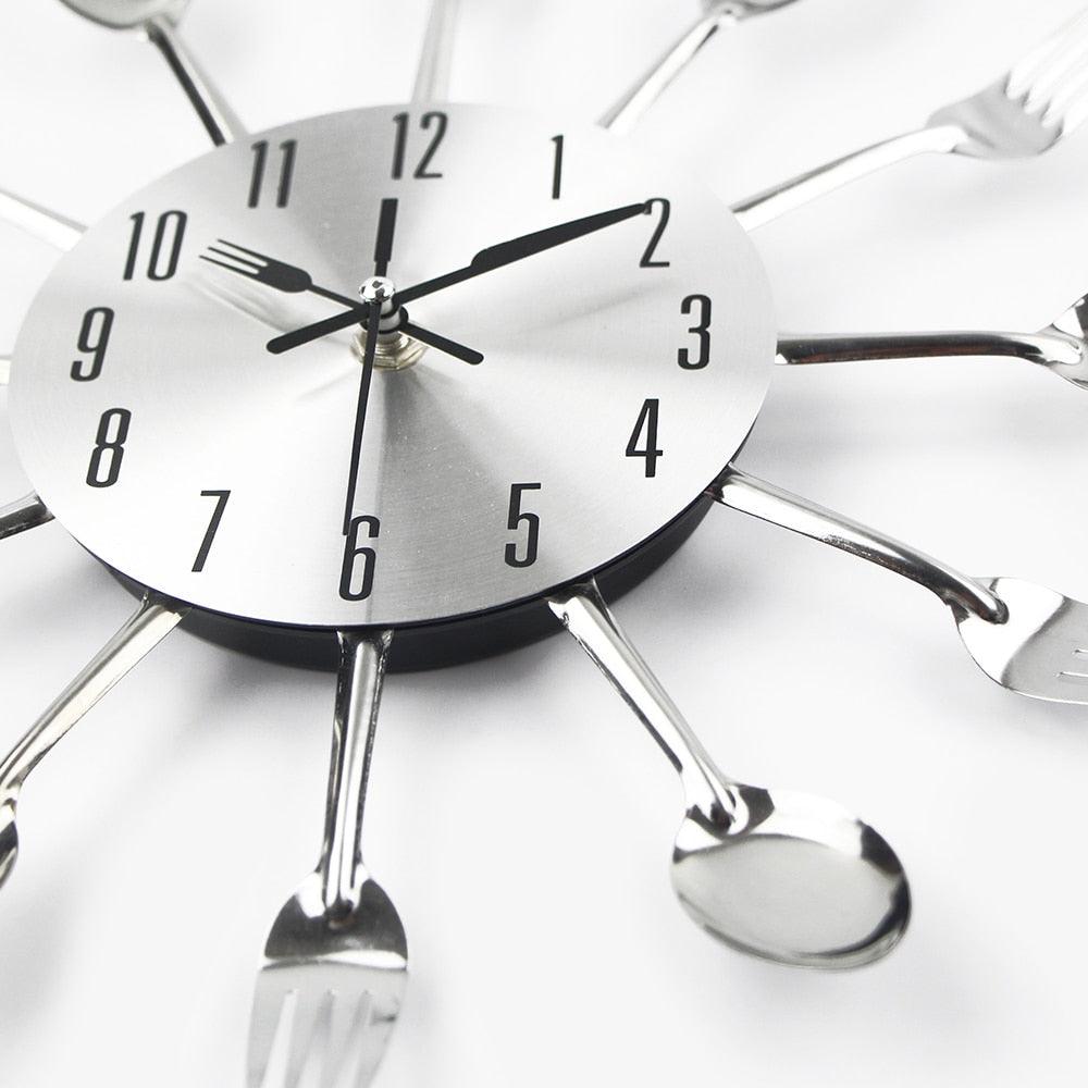 Stevvex silver metal kitchen wall clock with spoon and fork cutlery motif on Tampa Home & Garden Store