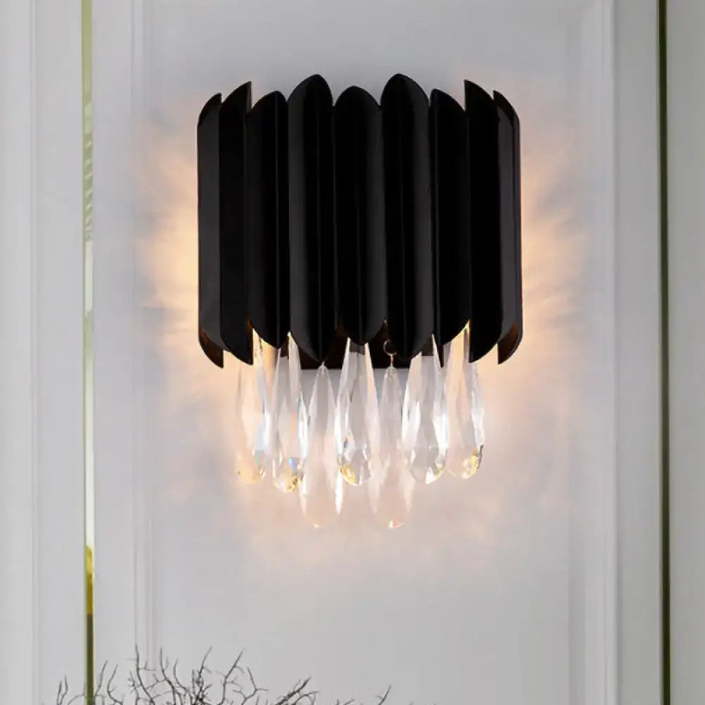 Black metal crystal sconce with vertical curved panels and hanging prisms Decorbites on Tampa Home & Garden Store
