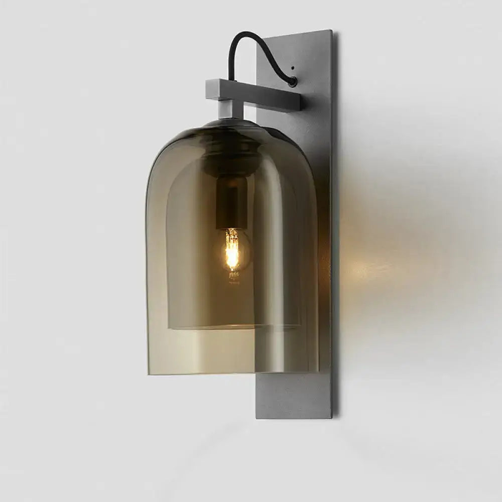 Black smoked glass wall sconce with metal backplate and exposed bulb on Tampa Home & Garden Store