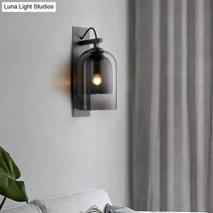 Decorbites black smoked glass sconce with a metal backplate and exposed bulb on Tampa Home & Garden Store